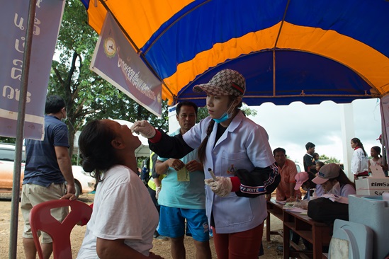 A health worker gives oral cholera vaccine.