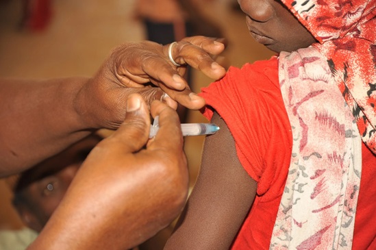 Health worker administers a vaccine