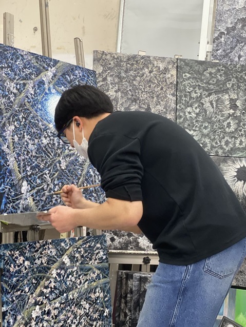 Jesung Bang, an artist, working on a painting in his studio